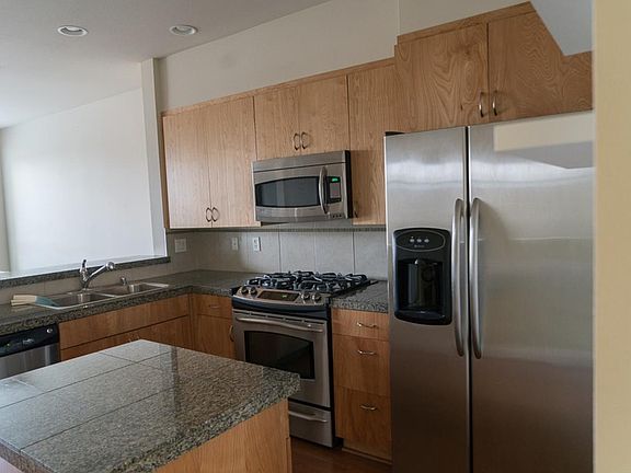 Open kitchen with stainless steel appliances. Great for ente