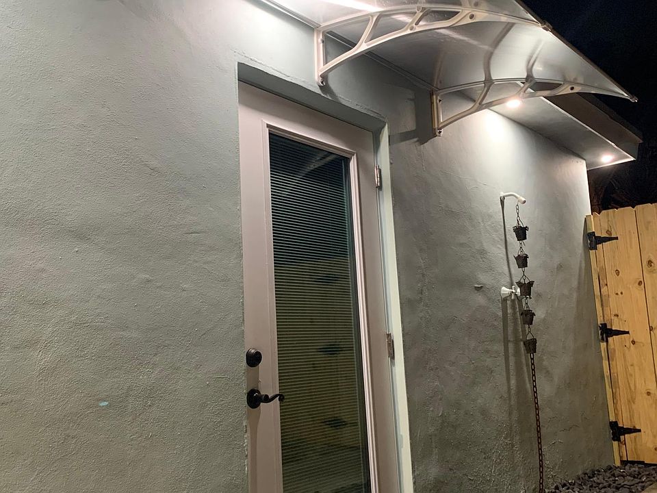 Private entrance, small outdoor patio space, night lighting