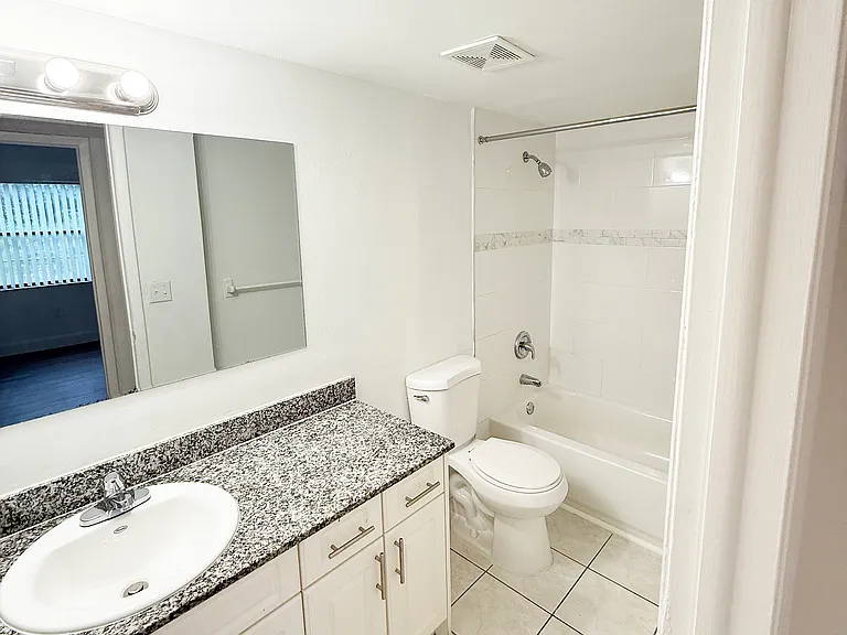 Modern bathroom with Granite Countertop and Sleek White Cabinetry