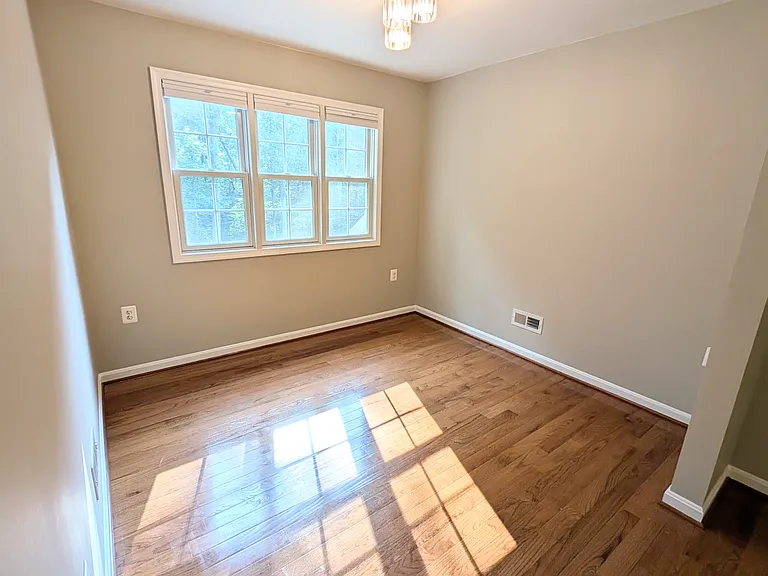 Left through kitchen from front door, looking at windows that view woods behind driveway