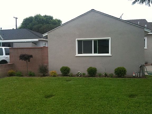 Street-view of Garage: New windows, paint, landscaping (with lava rock)