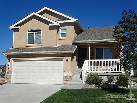 Exterior Front: Beautiful Stucco and Stone 4 Bedroom Home with Welcoming Covered Front Porch.