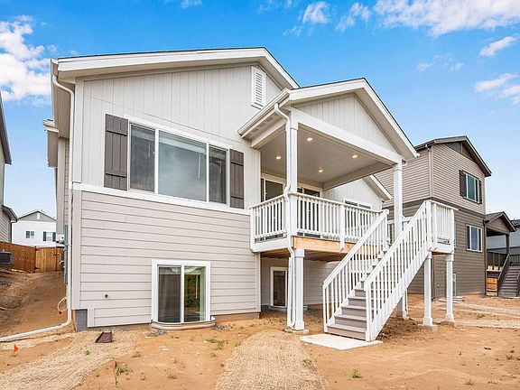 Rear exterior with covered deck and backyard