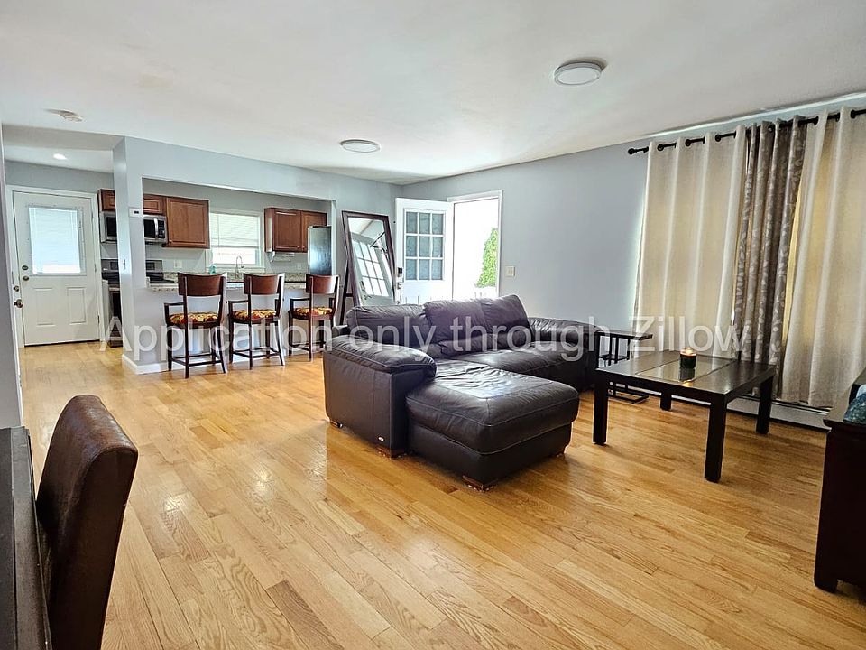 Living room showing side door and kitchen