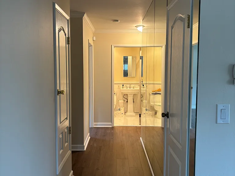 Mirrored hallway to bedrooms and second bathroom