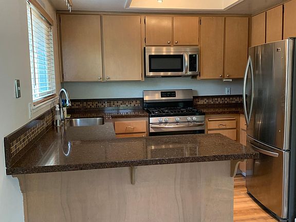 Kitchen with gas range and microwave.