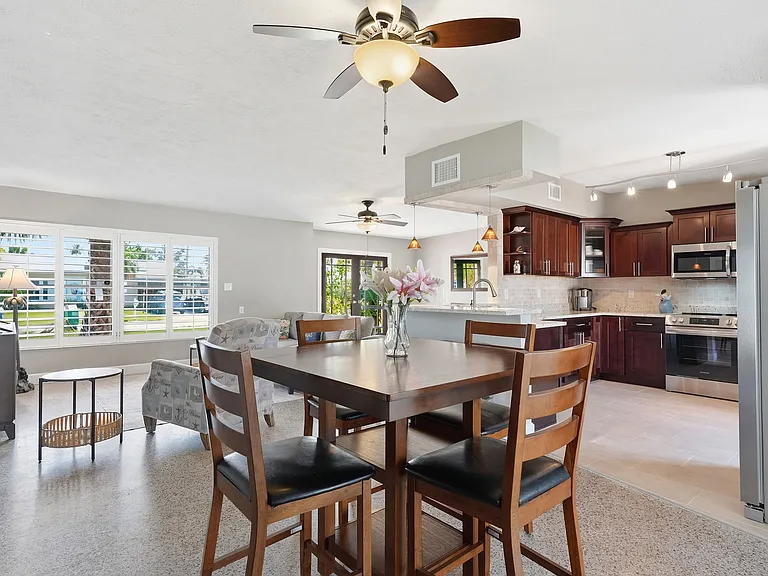 Wrap around high counter with bar stools with open kitchen, living area and dining table. Great for entertaining.