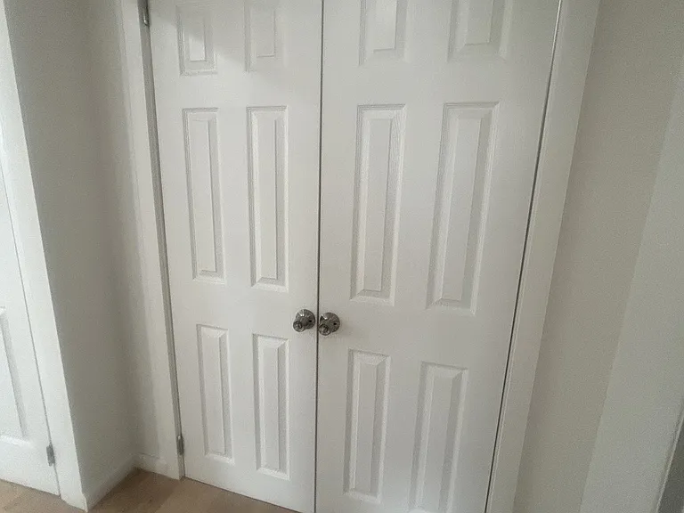 Large closet with storage above, below and custom shelves