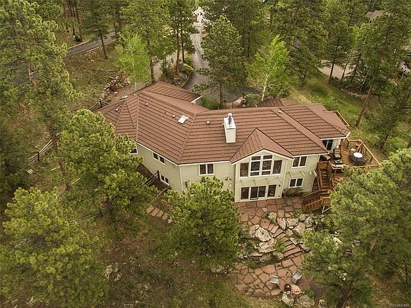 Aerial view of rear of home showing decks & flagstone terraces