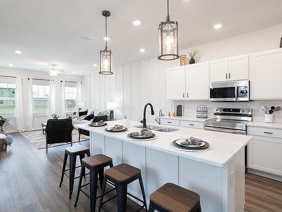 The Aria boasts an open and modern living area. - Aria home plan by Highland Homes