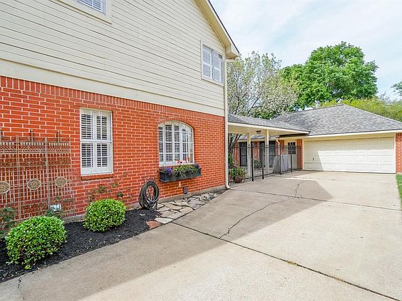 Elegant wrought iron fence with double wide drive way and planter window box add to the appeal of Laurel Park home.