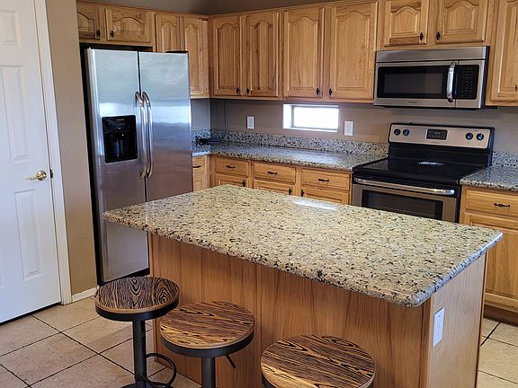 Updated kitchen with stainless appliances and granite countertops.