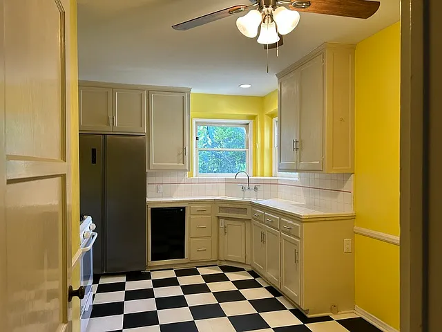 Huge gourmet kitchen with double door fridge, dishwasher, stove, disposal and tile countertops
