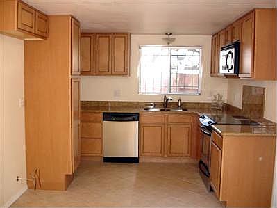 The large kitchen includes new cabinetry, granite counter tops, all new stainless steel appliances with under counter sink and a new tile floor on the diagonal. 