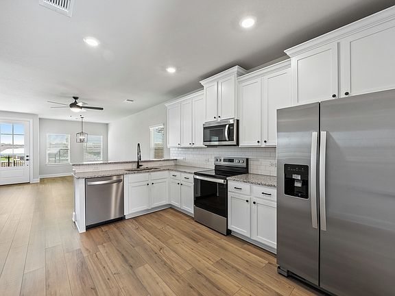 The kitchen has stainless steel appliances.