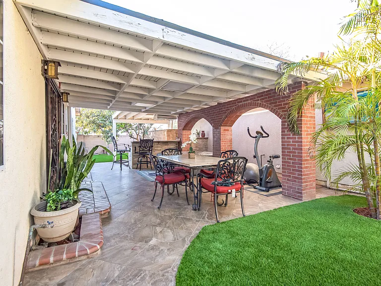 Beautiful outdoor seating area with grill and mini bar.
