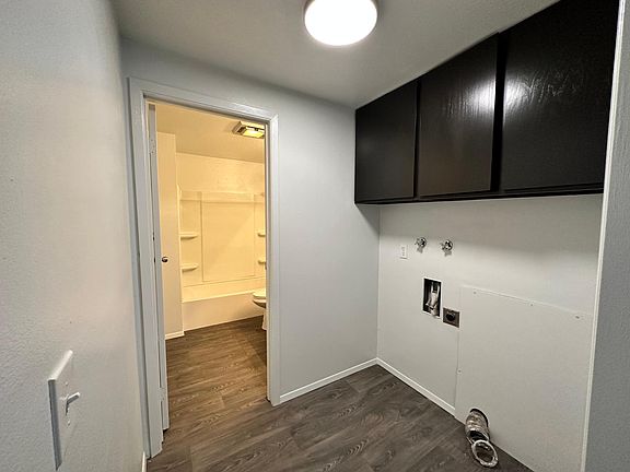 Laundry room and entrance to bathroom. Laundry room has full size washer and dryer hookups.