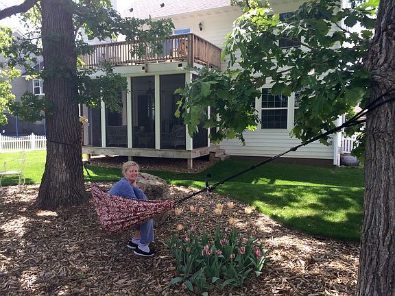 View of back screened porch and upper deck. 