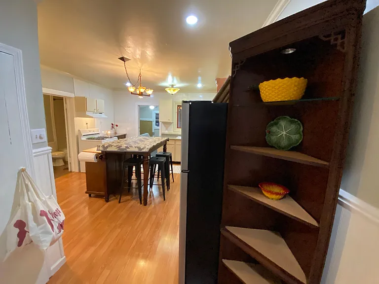 The lighted refrigerator shelves near the kitchen pantry with the original barn-styled door!