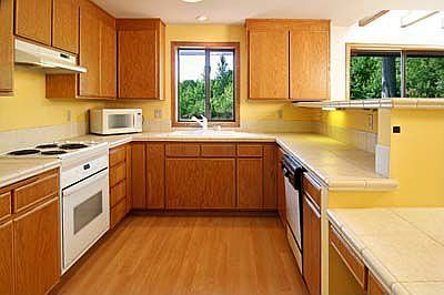 The kitchen has been updated with tile counters