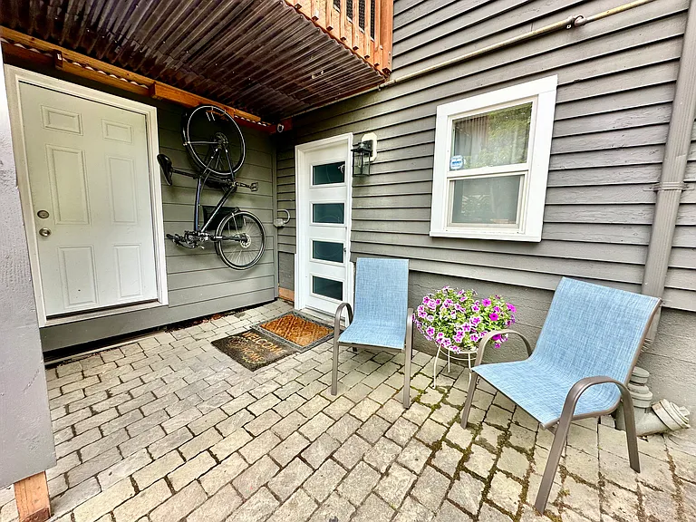 Unit Entrance with ability to store a hanging bike out of the weather. The left door is the owner's shed.