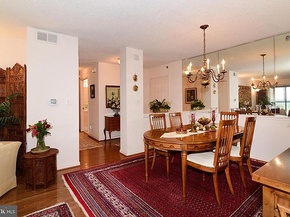 Dining room with mirror wall for added decor.