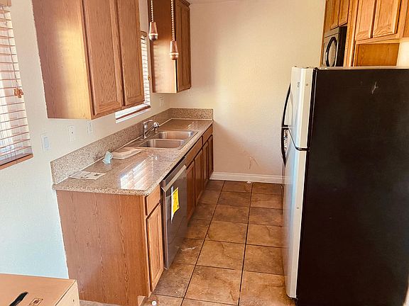 Kitchen with granite countertops, double sink, and brand new stainless steel LG appliances.
