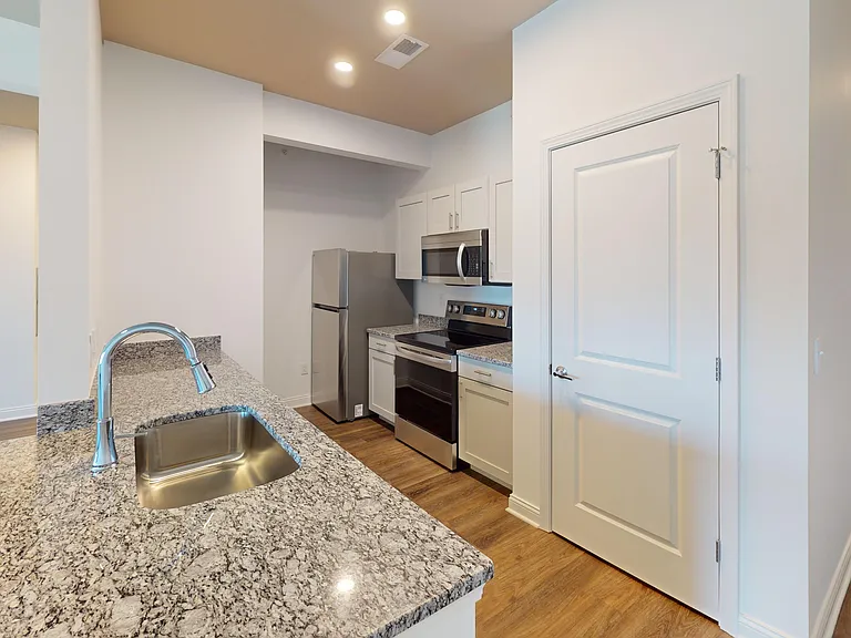 The Pyle floor plan's kitchen includes a pantry, granite countertops, breakfast bar, and stainless steel appliances. The Pyle floor plan's kitchen includes a pantry, granite countertops, breakfast bar, and stainless steel appliances.