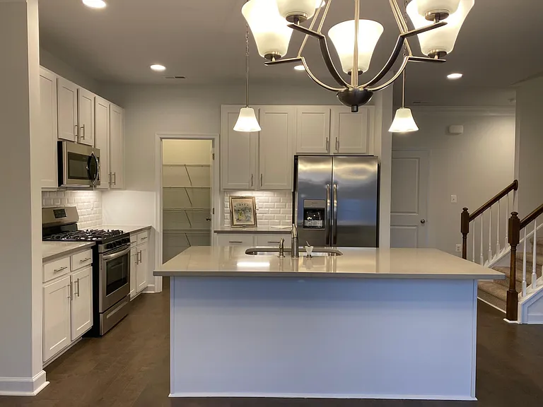 Large Island and walk in pantry. Double door refrigerator and stainless steel appliances. Gas stove, Microwave and dishwasher.