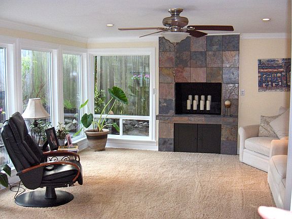 Family room w/  custom slate fireplace & crown molding thru-out, French doors 
