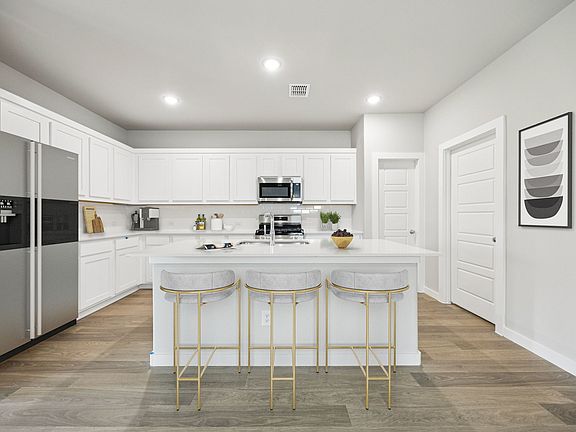 Kitchen in the Hayden home plan by Trophy Signature Homes - REPRESENTATIVE PHOTO