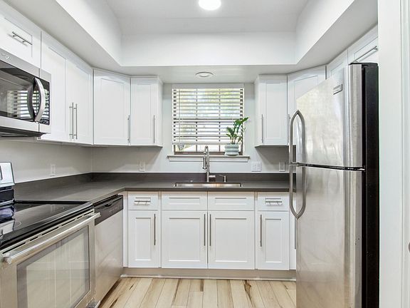 Fully renovated kitchen with brand new shaker cabinets, quartz countertops and stainless steel appliances.