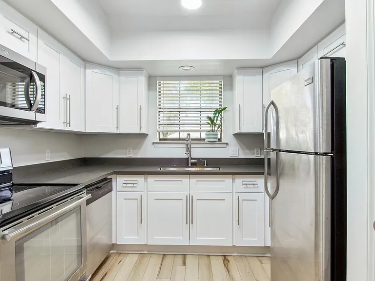 Fully renovated kitchen with brand new shaker cabinets, quartz countertops and stainless steel appliances.