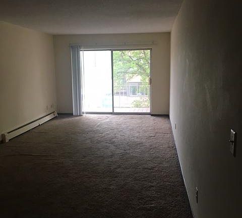 Large living room with deck overlooking downtown skylights