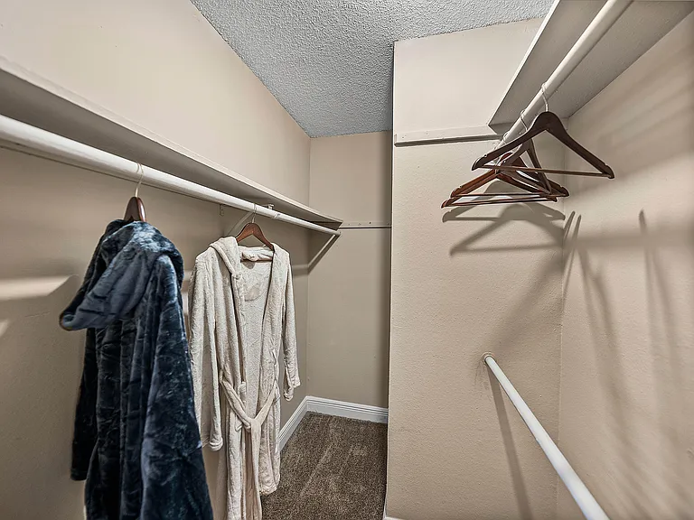Generous walk-in closet with ample hanging space for easy organization.