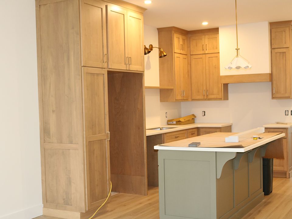 2nd floor kitchen with high ceiling, maple cabinets and bar. Solid surface countertops and new stainless appliances (including DW)