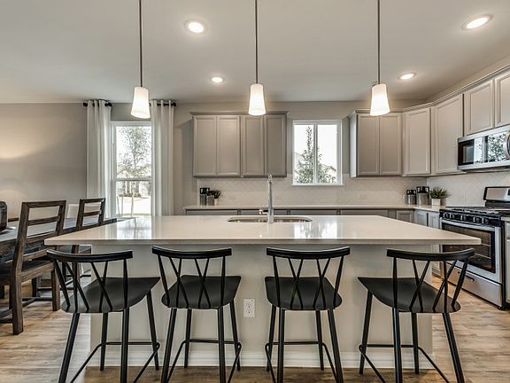 Gorgeous kitchen with recessed and pendant lighting model representation
