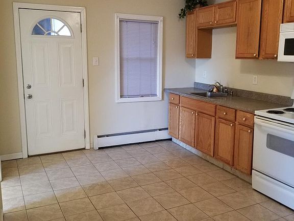 nice big tile Kitchen with build in microwave, stove, refrig