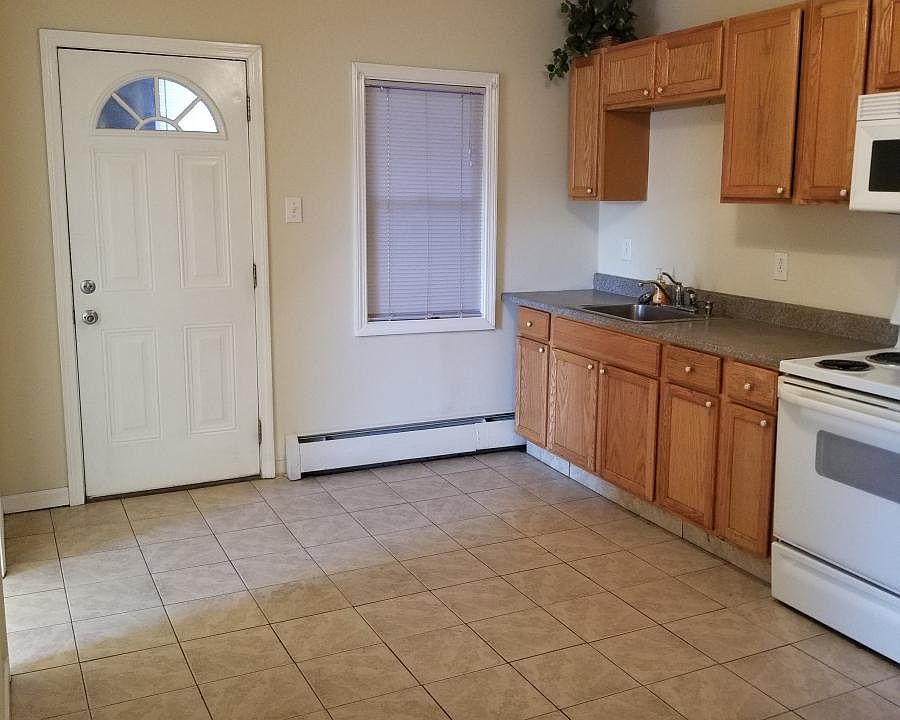 nice big tile Kitchen with build in microwave, stove, refrig