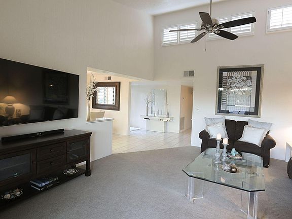 The light filled living room with high vaulted ceilings has clerestory and full length windows that create a spacious and open atmosphere.