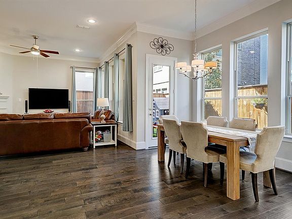 Open first floor living with warm, upgraded hardwood floors and sweeping backyard views