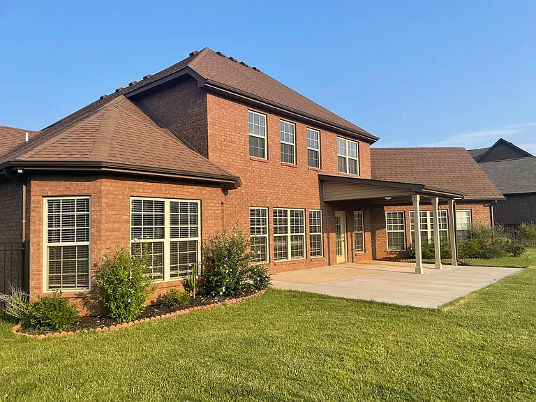 Patio providing ample space for gatherings and outdoor living. Covered patio also features a ceiling fan.