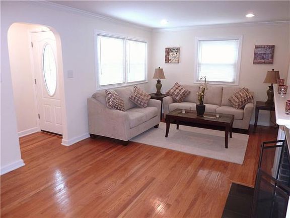 Foyer entry with coat closet opens to living room