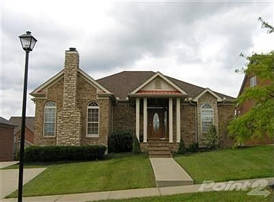 This beautiful ranch home is all brick with some cut stone accents. The yard is nearly level and is 