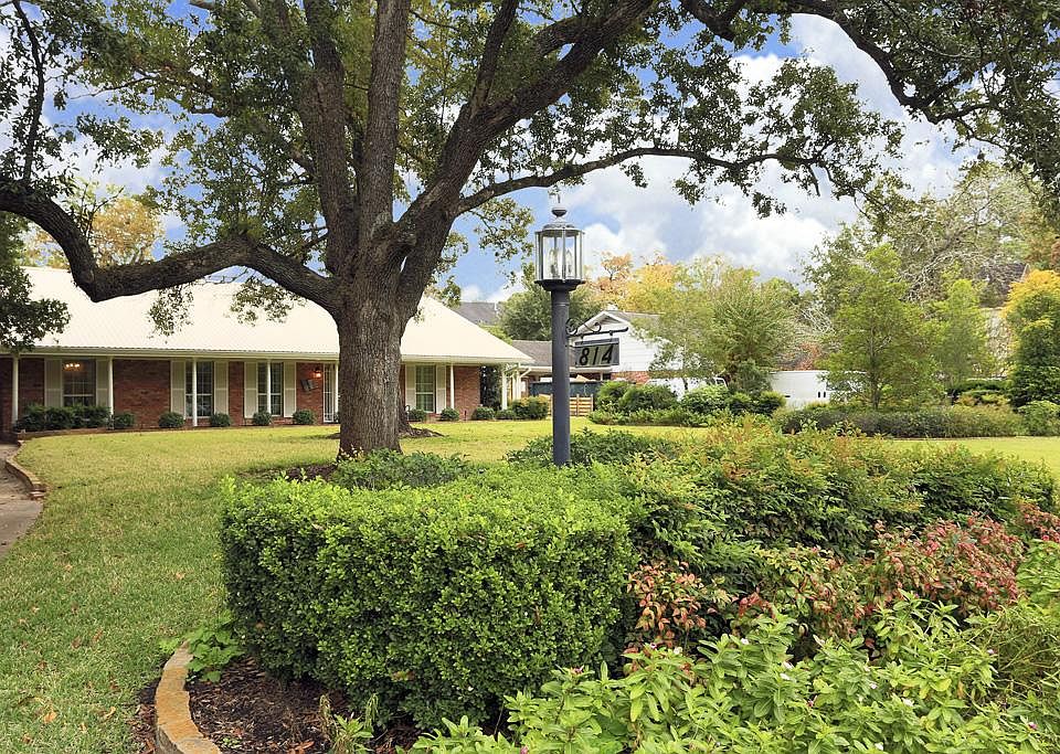 Front view showing one of the large trees on the front of the property.