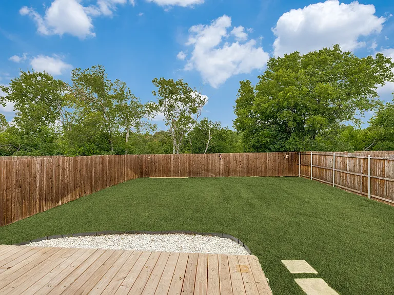 Private backyard backs up to green space.