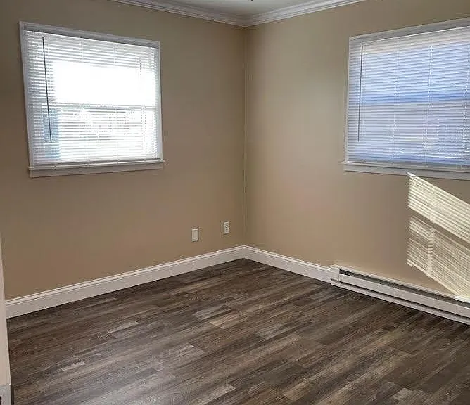 Bedroom 2 with ceiling fan new blinds and new baseboard heat