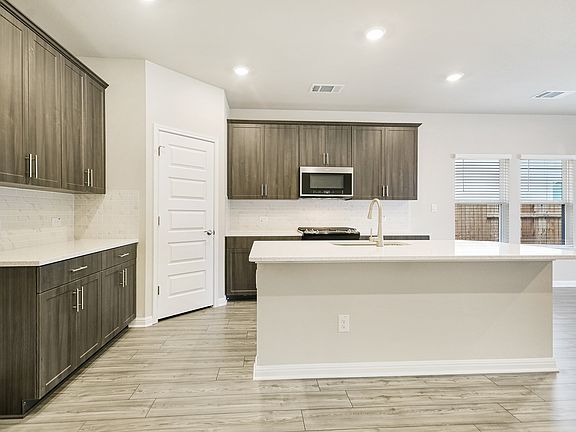 This kitchen features Tahoe Slate-colored cabinets and quartz countertops.