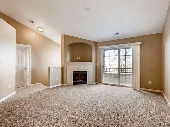 Large living room with vaulted ceiling, fireplace and mounta