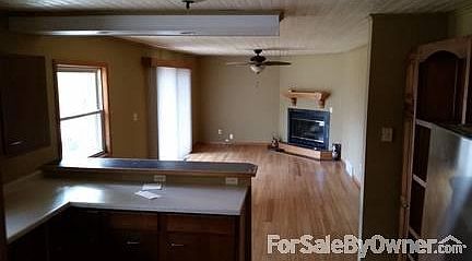 Kitchen and living room : open concept living area with new flooring and ceiling.